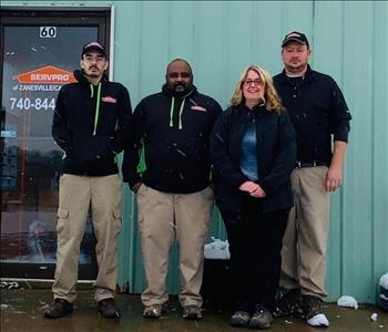Photo of crew outside building wearing SERVPRO attire